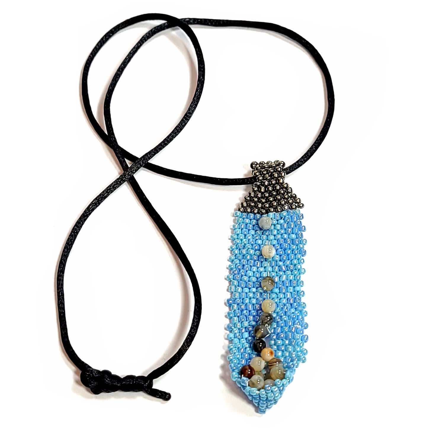 necklace of black cord with a pendant made from blue seed beads with gray seed beads and slightly larger brown beads.