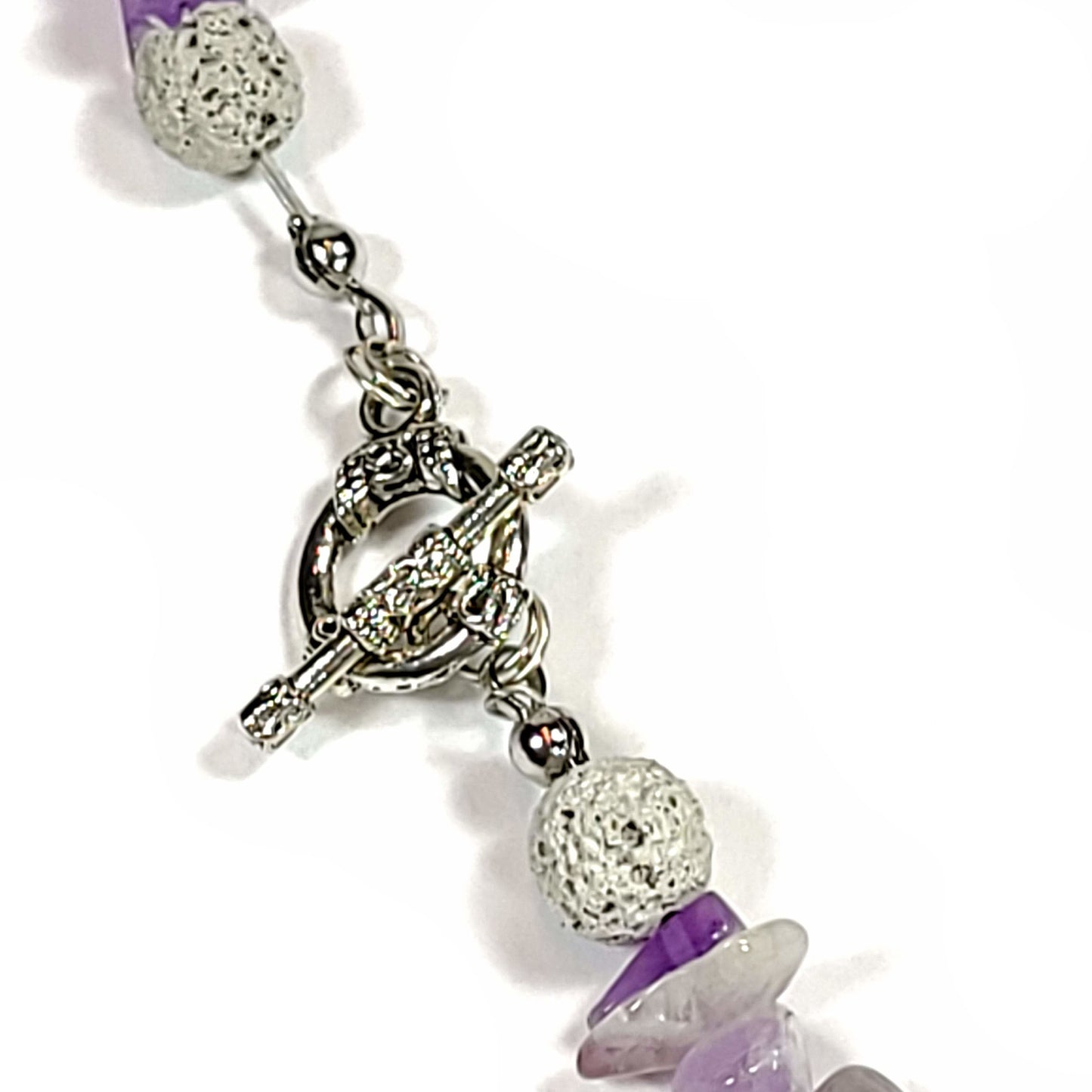 Amethyst chip and white lava rock necklace toggle clasp close up.