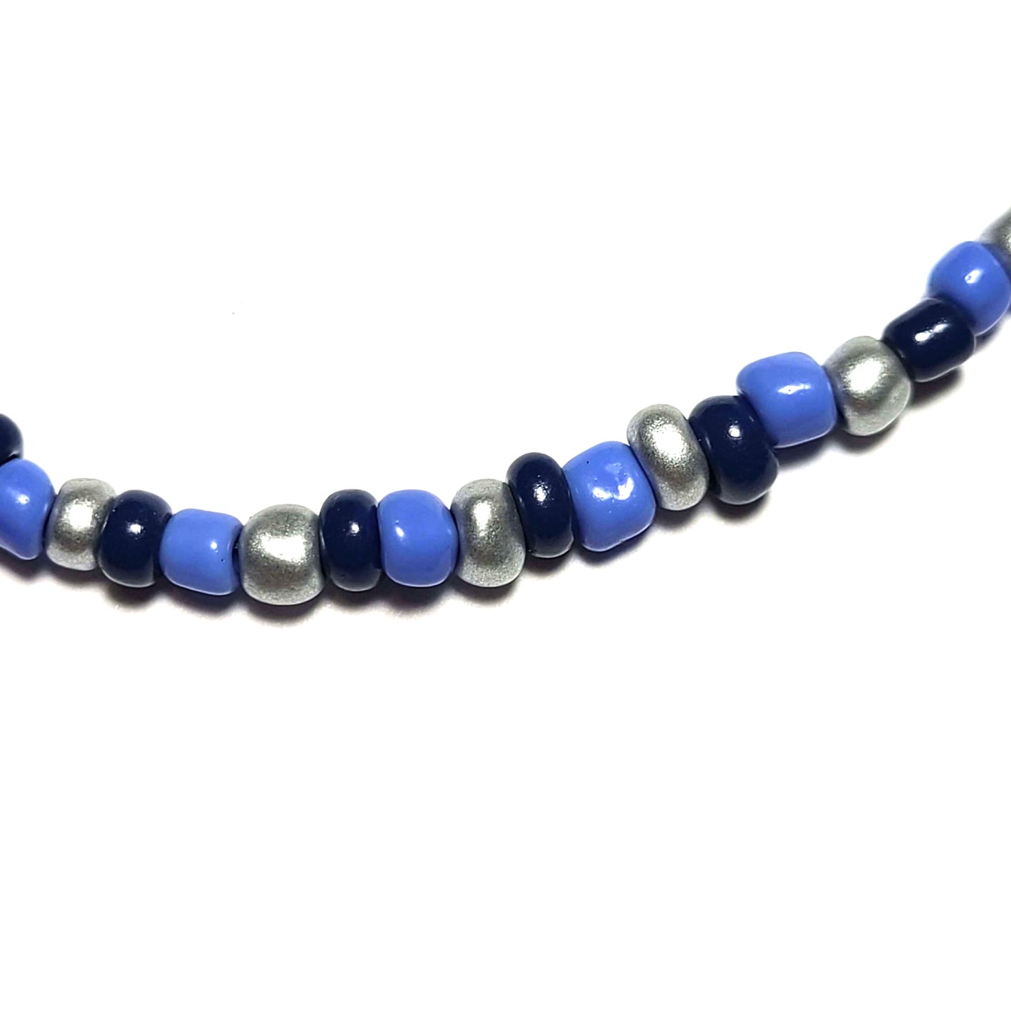 Closse up of a single strand necklace made with sky blue, navy blue, and silver beads.