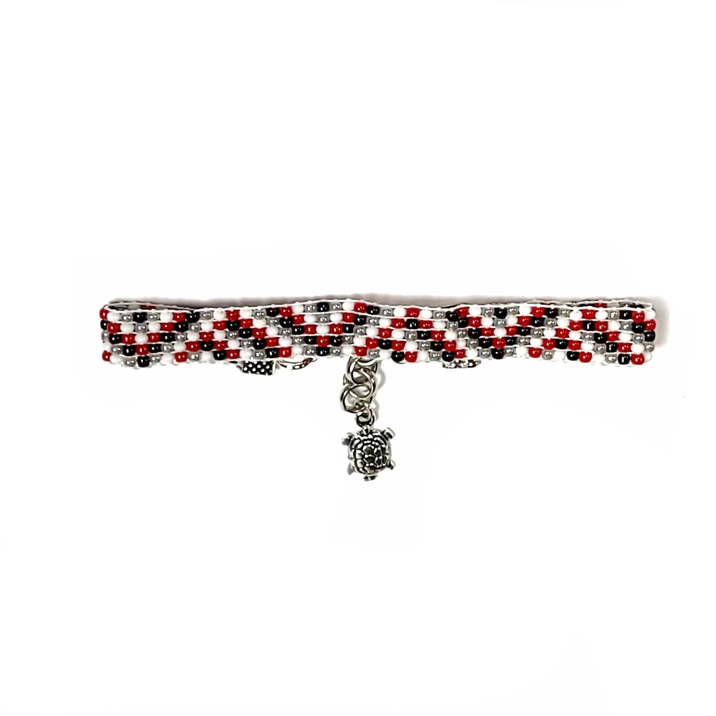 Woven handmade seed bead bracelet with red, white, black and light gray seed beads. Silver toned end clips with silver toned lobster clasp and silver toned turtle charm.
