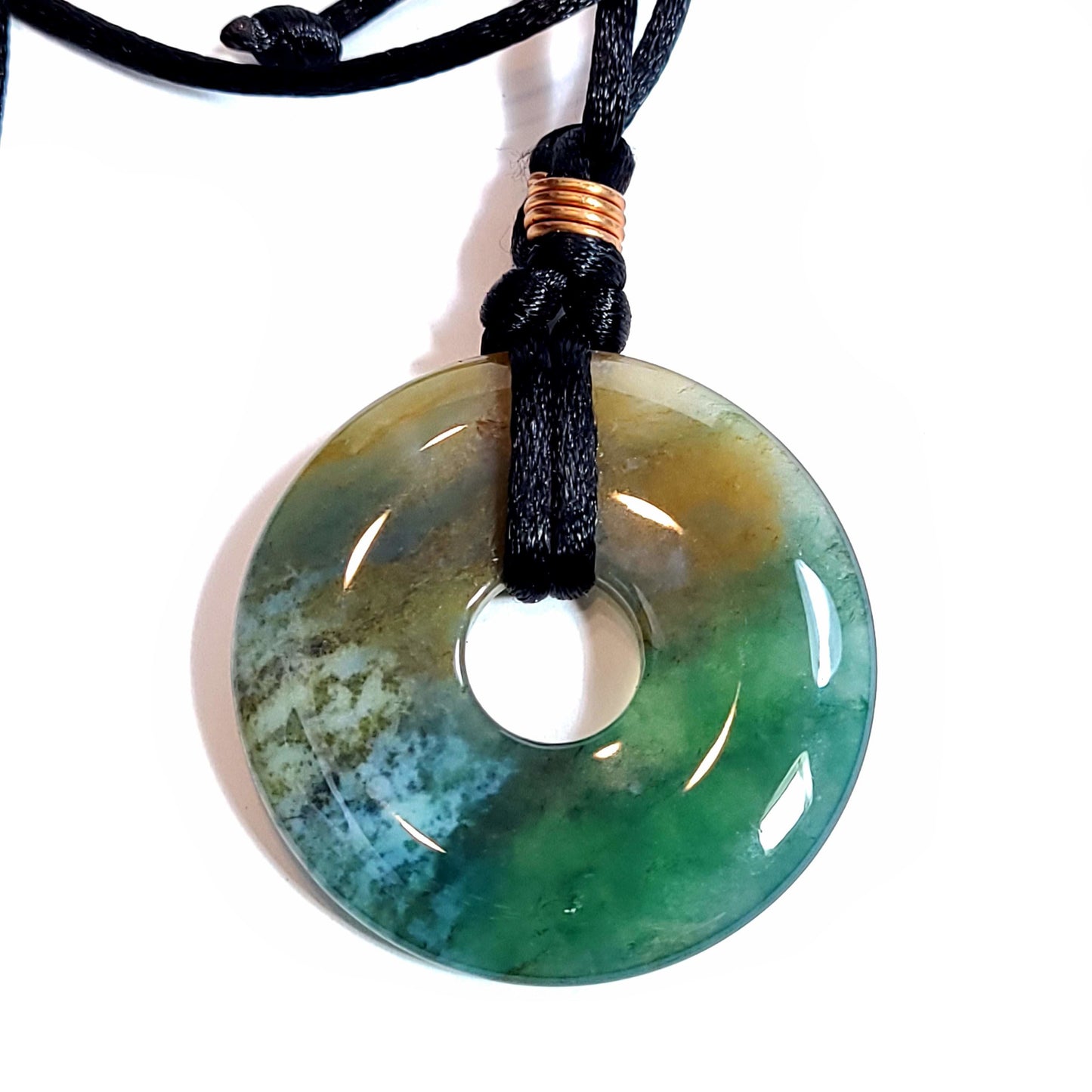 Doughnut shaped agate stone on a satiny black cord necklace