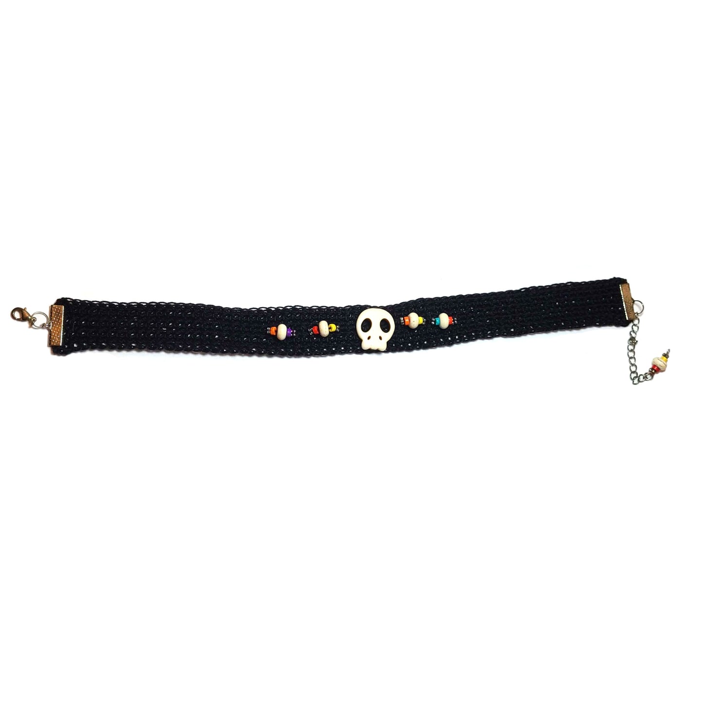 Black crocheted choker with white skull in center, flanked by decorative beads of blue, yellow, white, orange, and red, and silver spacers.