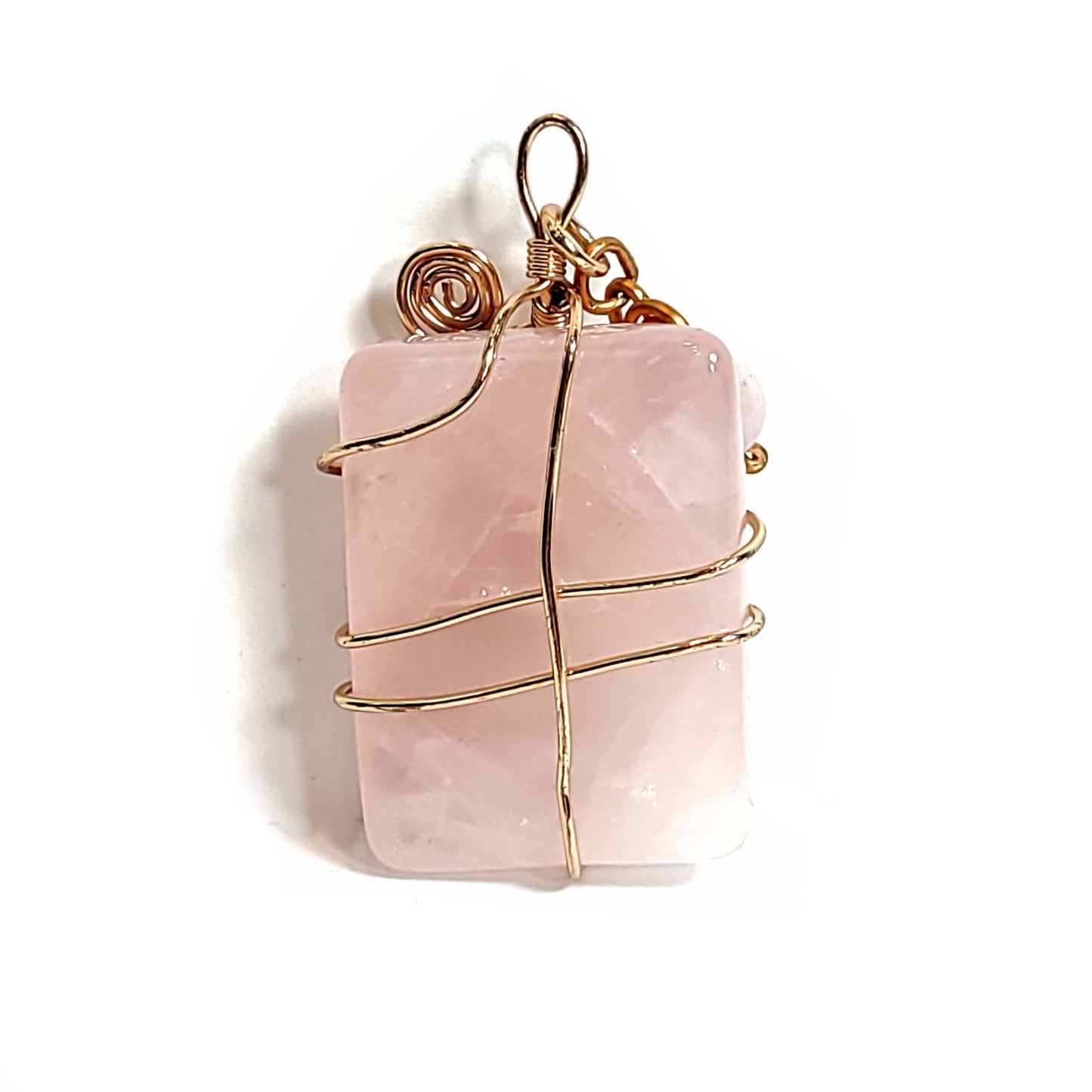 Back of Rose quartz stone pendant wrapped with rose gold plated wire. Crowned with a rose quartz and distressed copper wire floating charm.