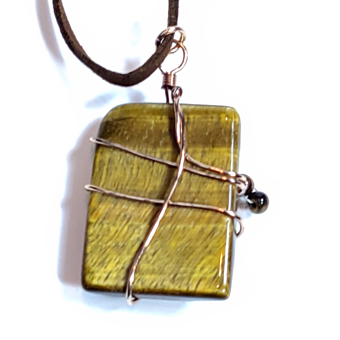 Polished tiger eye stone wire wrapped pendant. It has a floating 4 tiger eye bead charm, rose gold plated and copper wire. Back View.