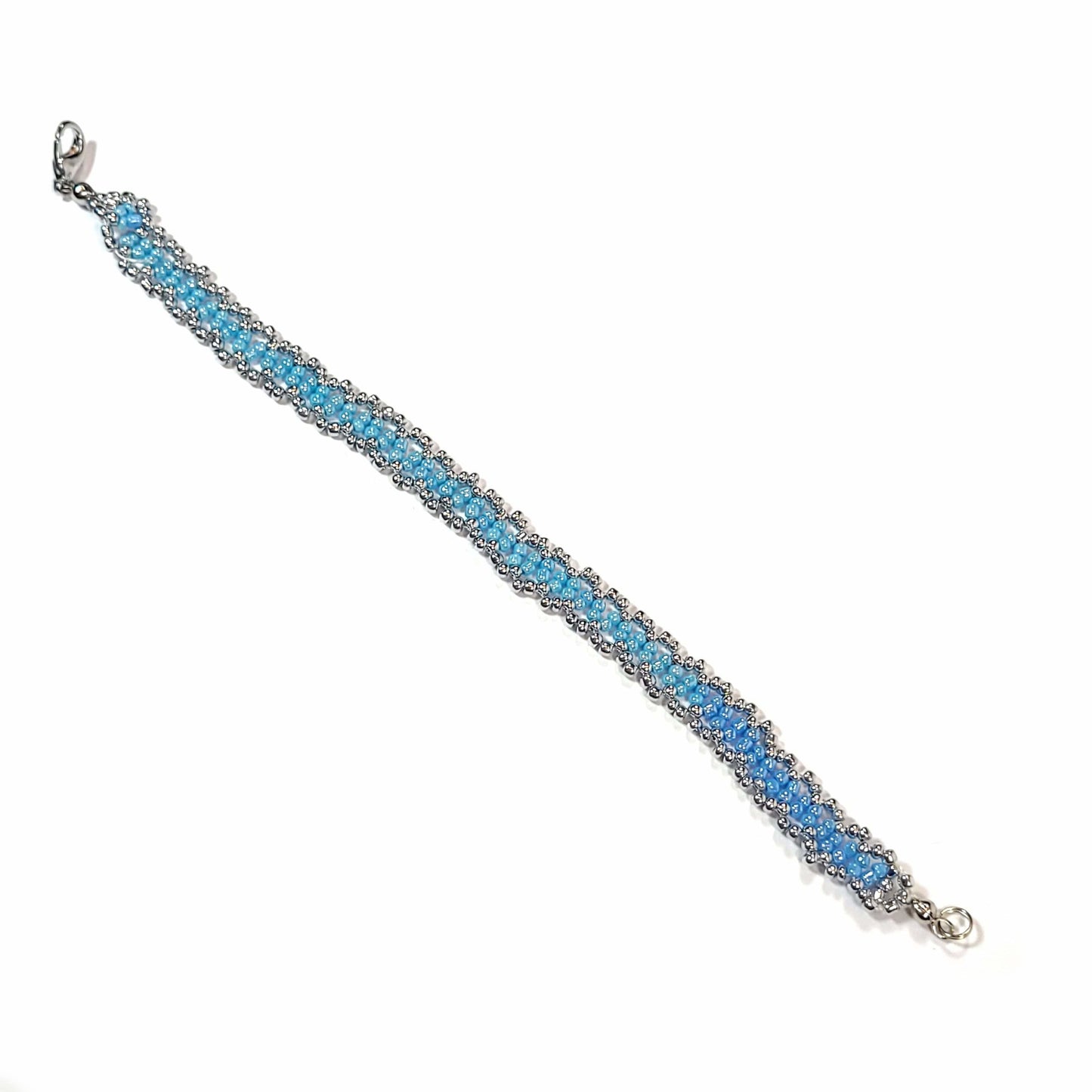 Bracelet made with powder blue and silver colored seed beads, with a silver colored lobster clasp.
