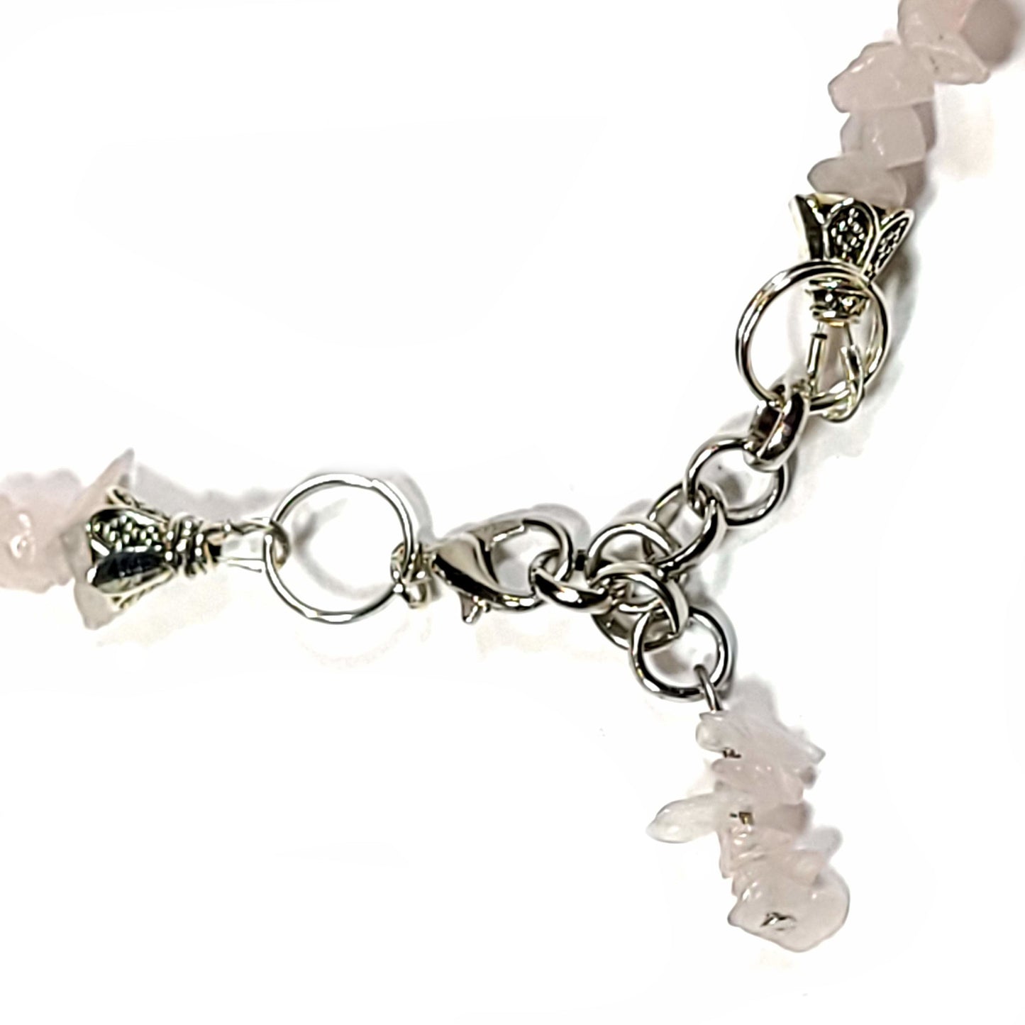 Necklace made of Rose quartz chips and Howlite turtles with silver tone end caps, extender chain and lobster claw. clasp and dangle view.