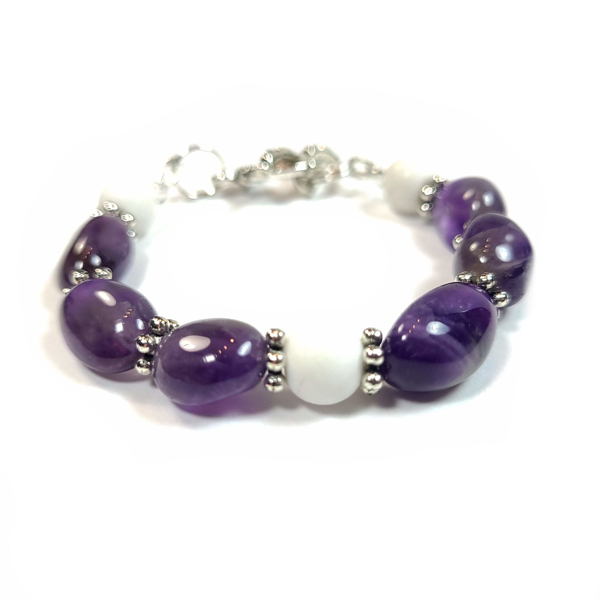 Bracelet made of amethyst pebble beads and white quartz beads with a silver color ltoggle clasp.