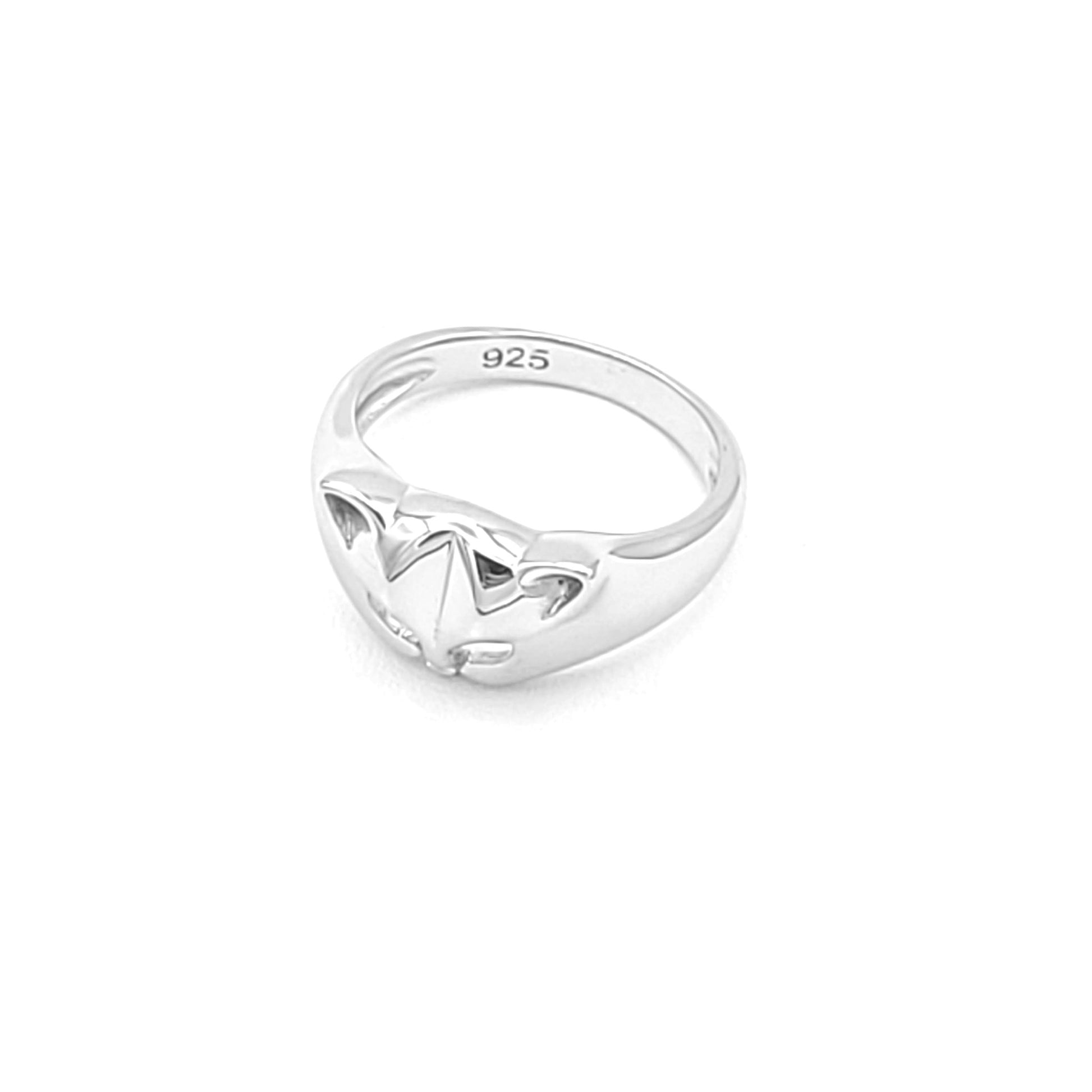 Silver ring with a cat face and ears. The eyes are cut outs of the metal. The ring is tapered down to the sides from the cat head. The inside of the band is stamped with "925."