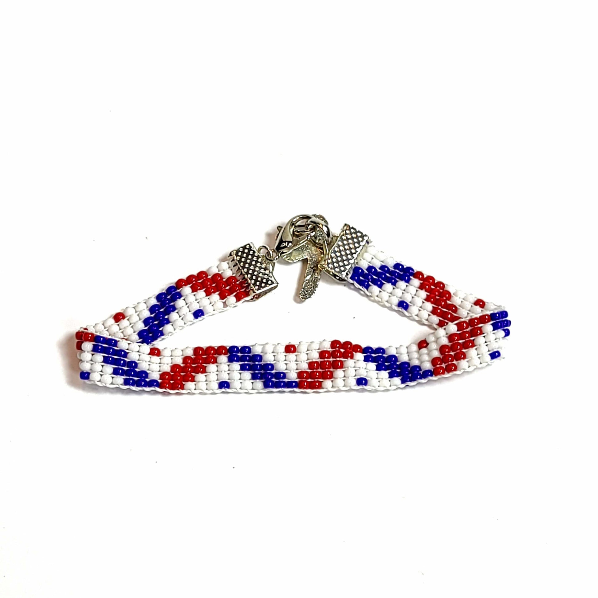 Woven seed bead bracelet with red, white, and blue seed beads. Silver toned end clips with silvertoned lobster clasp and silvertoned dragonfly charm.   