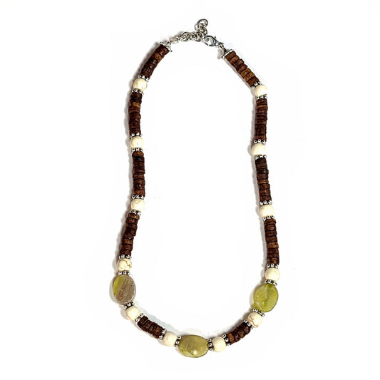 Handmade necklace with heshi shaped coconut shell beads, howlite beads, and matte green fluorite beads highlighted with silver tone spacer beads. End caps are silver tone with lobster clasp and an extender chain.