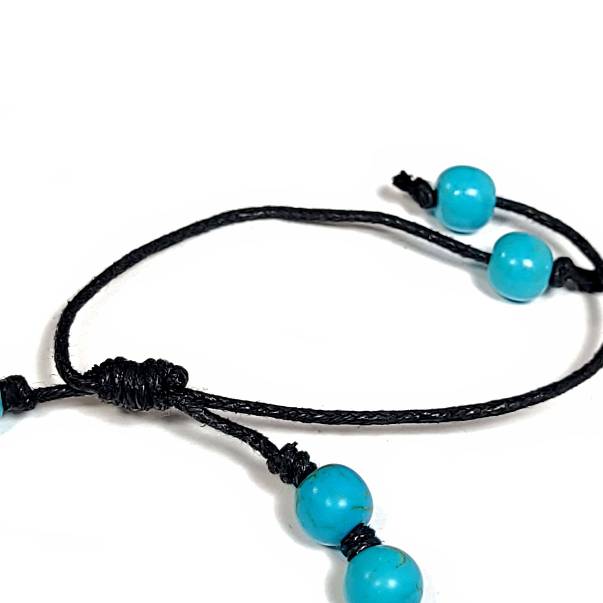 Close up view of the adjustable know on a handmade knotted blue turquoise dyed Howlite Bracelet/Anklet. Adjustable slip knot makes easy size adjustment.