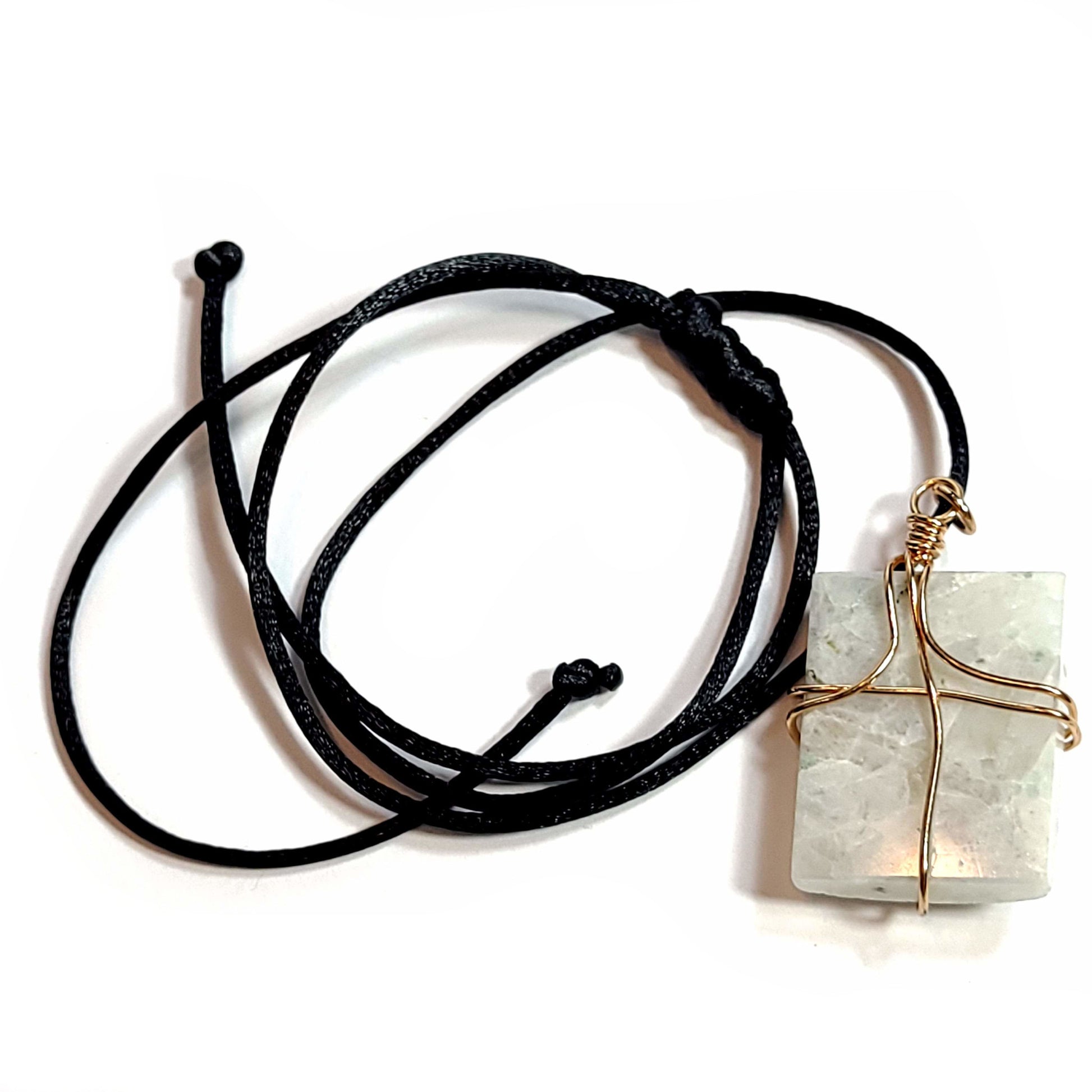 Rose wire wrapped Quartz pendant with tiny bits of black Tourmaline. Comes with a black satin cord with an adjustable slip knot. Stone has some minor natural pits and has a slight chip in the upper left corner.