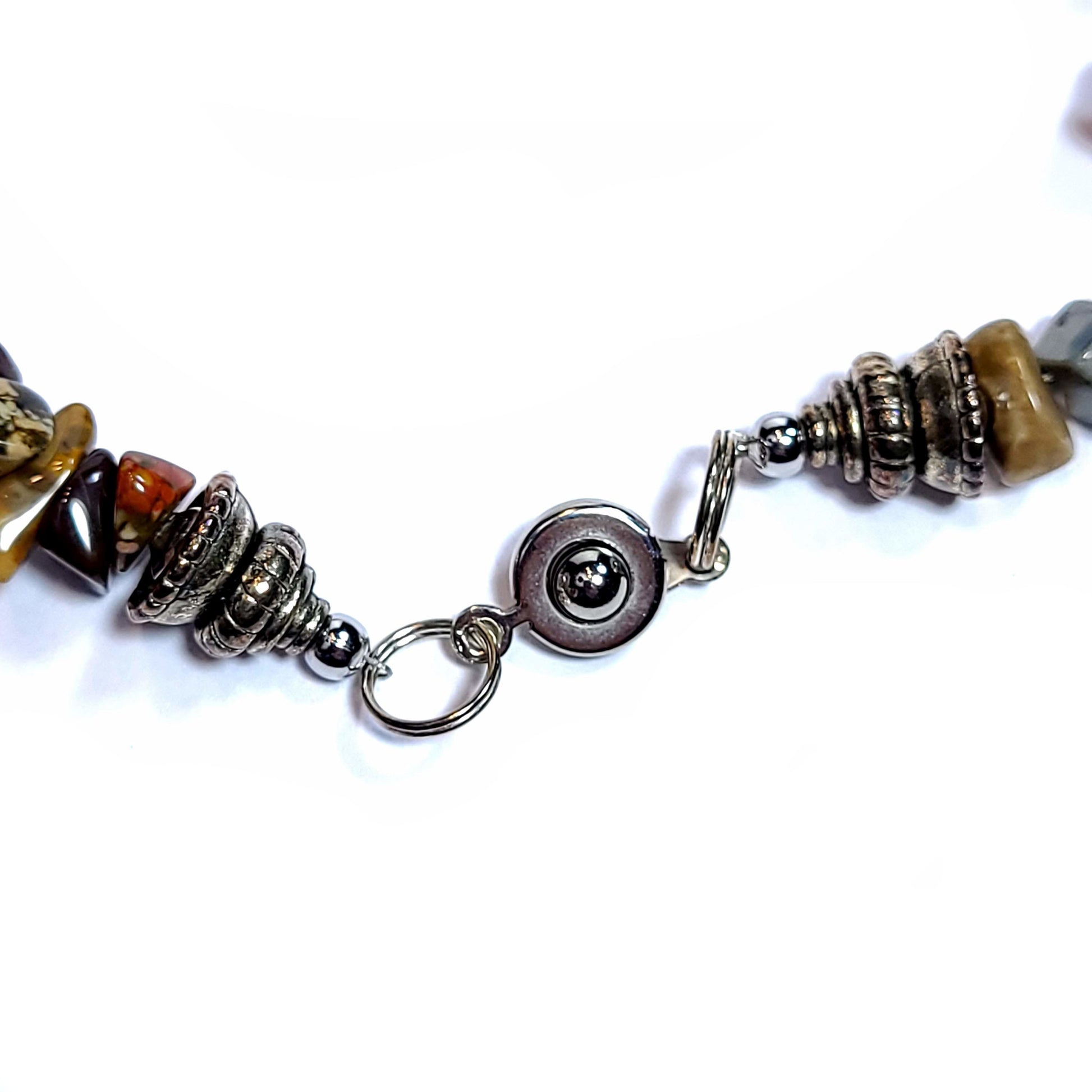Closed clasp of a handmade Necklace with vintage shells, jasper chip beads, and 5 10mm turquoise dyed beads.