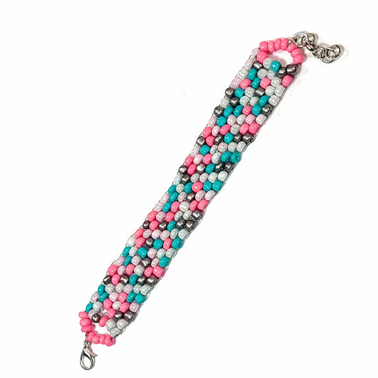 Bracelet made of pink, white, light blue, and silver colored beads with a silver colored lobster clasp and extension chain.