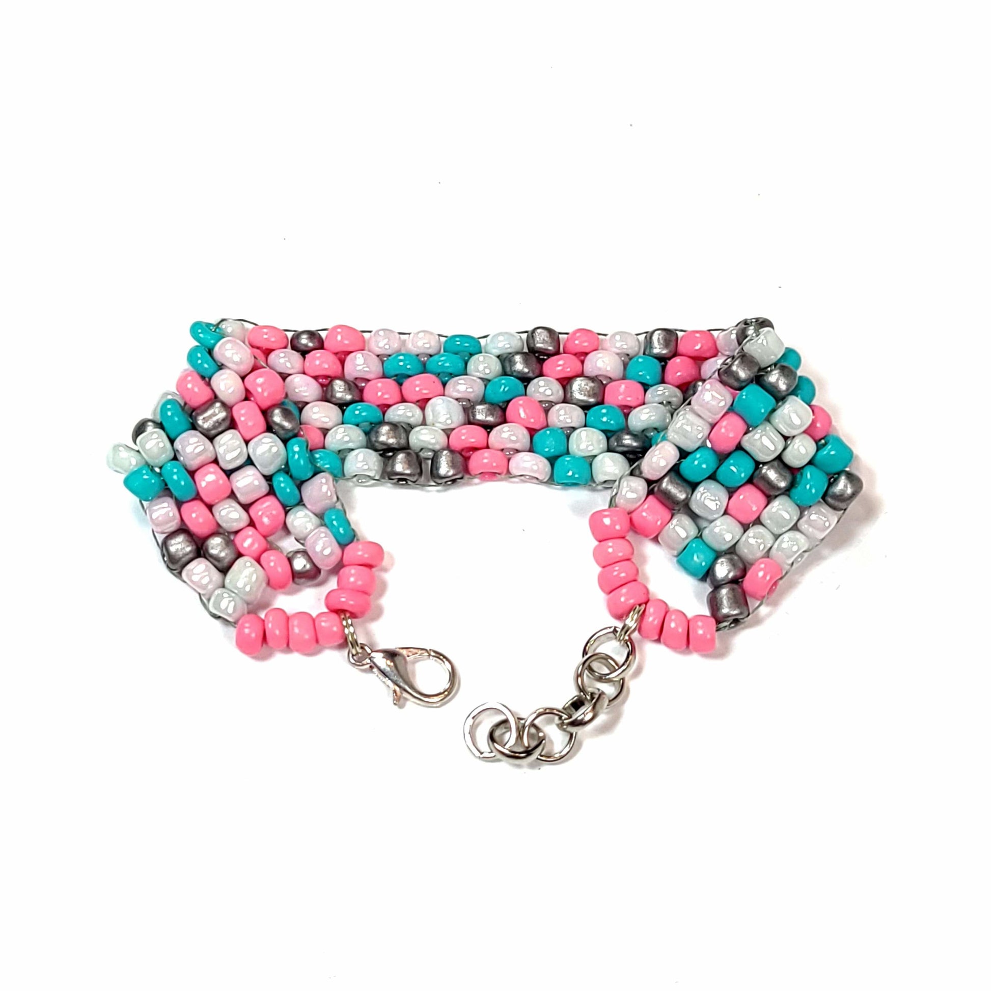 Bracelet made of pink, white, light blue, and silver colored beads with a silver colored lobster clasp and extension chain.