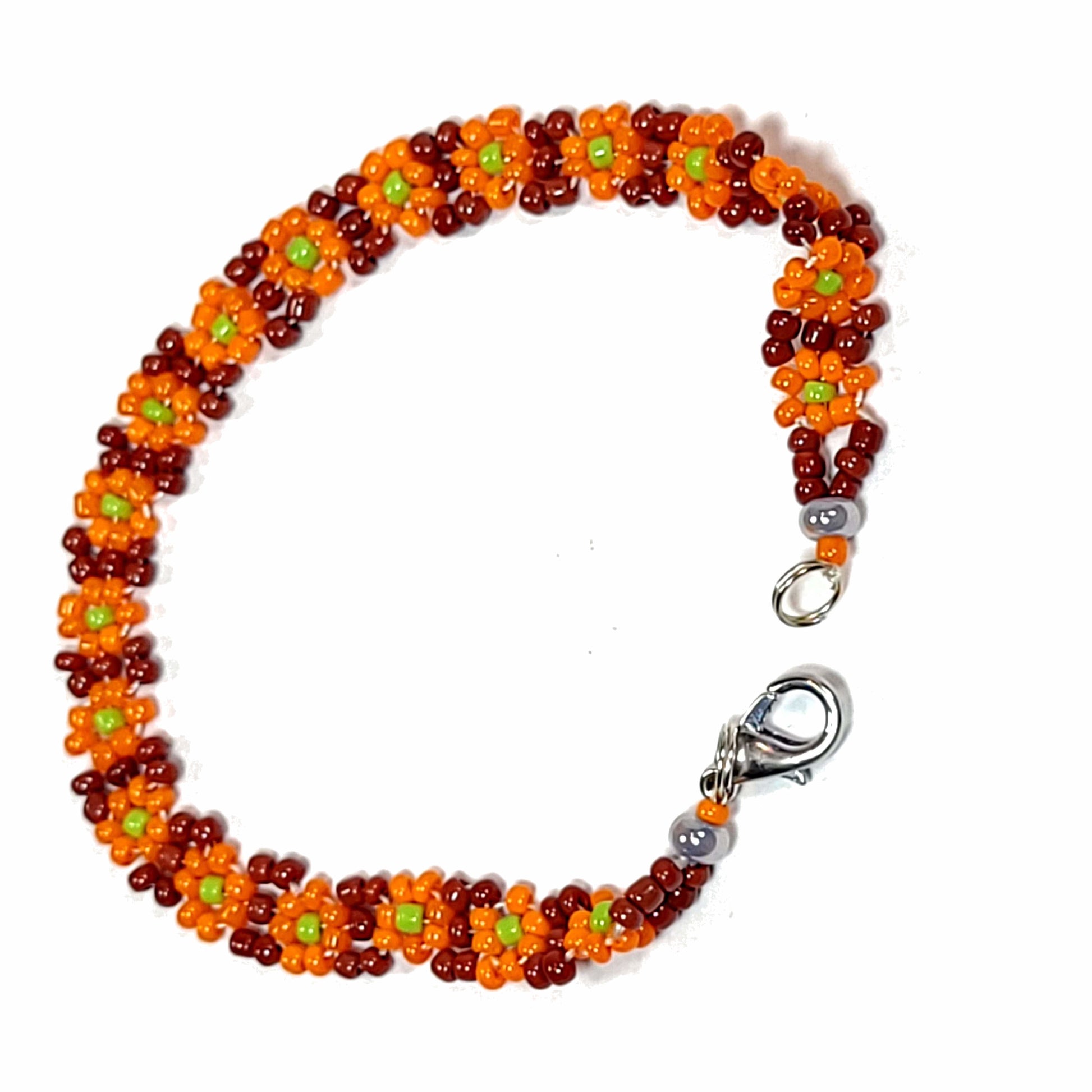Orange daisy chain bracelet. Made with pumpkin orange flowers, lime green center, and brown background. Silver colored lobster claw clasp.