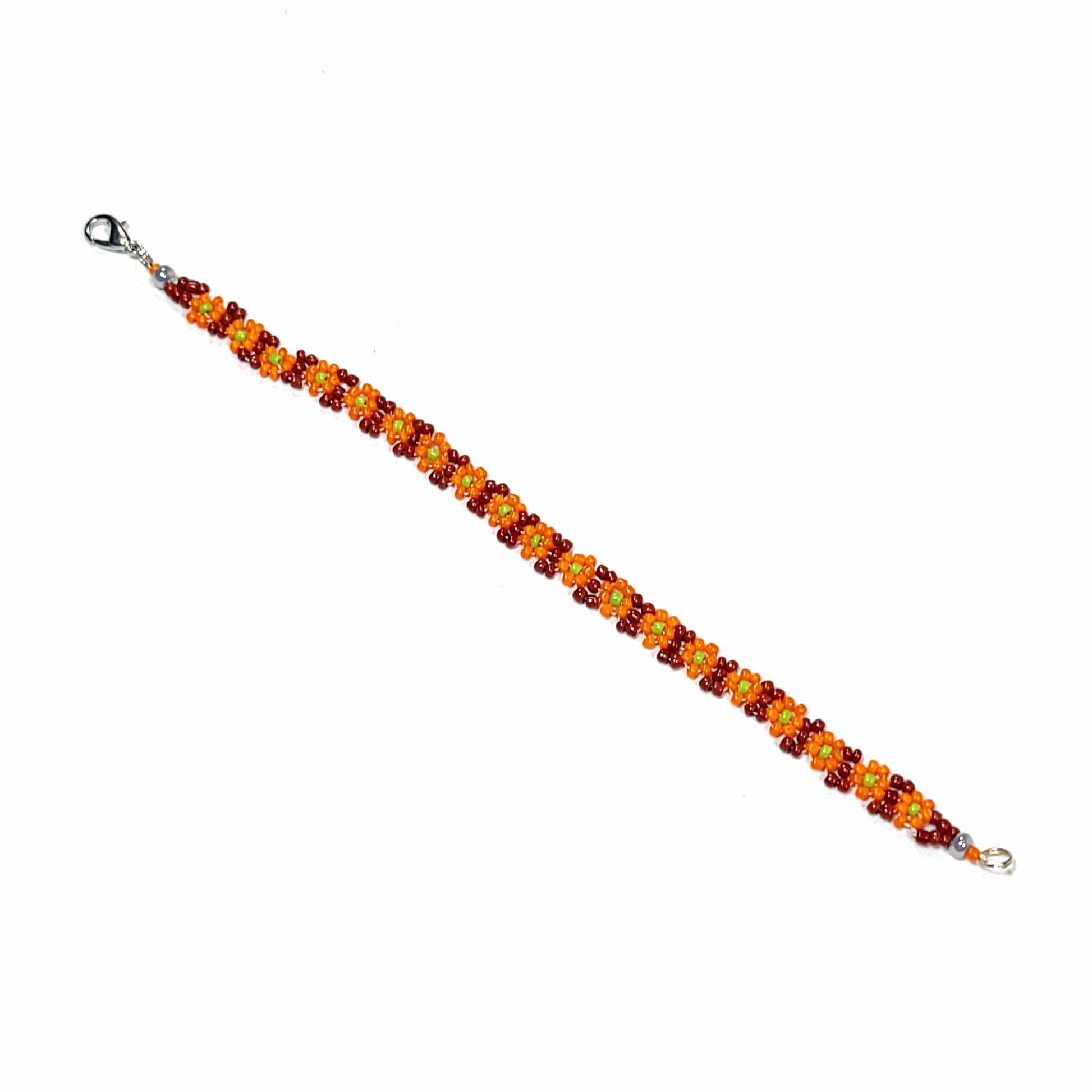 Full view of Orange daisy chain bracelet. Made with pumpkin orange flowers, lime green center, and brown background. Silver colored lobster claw clasp.