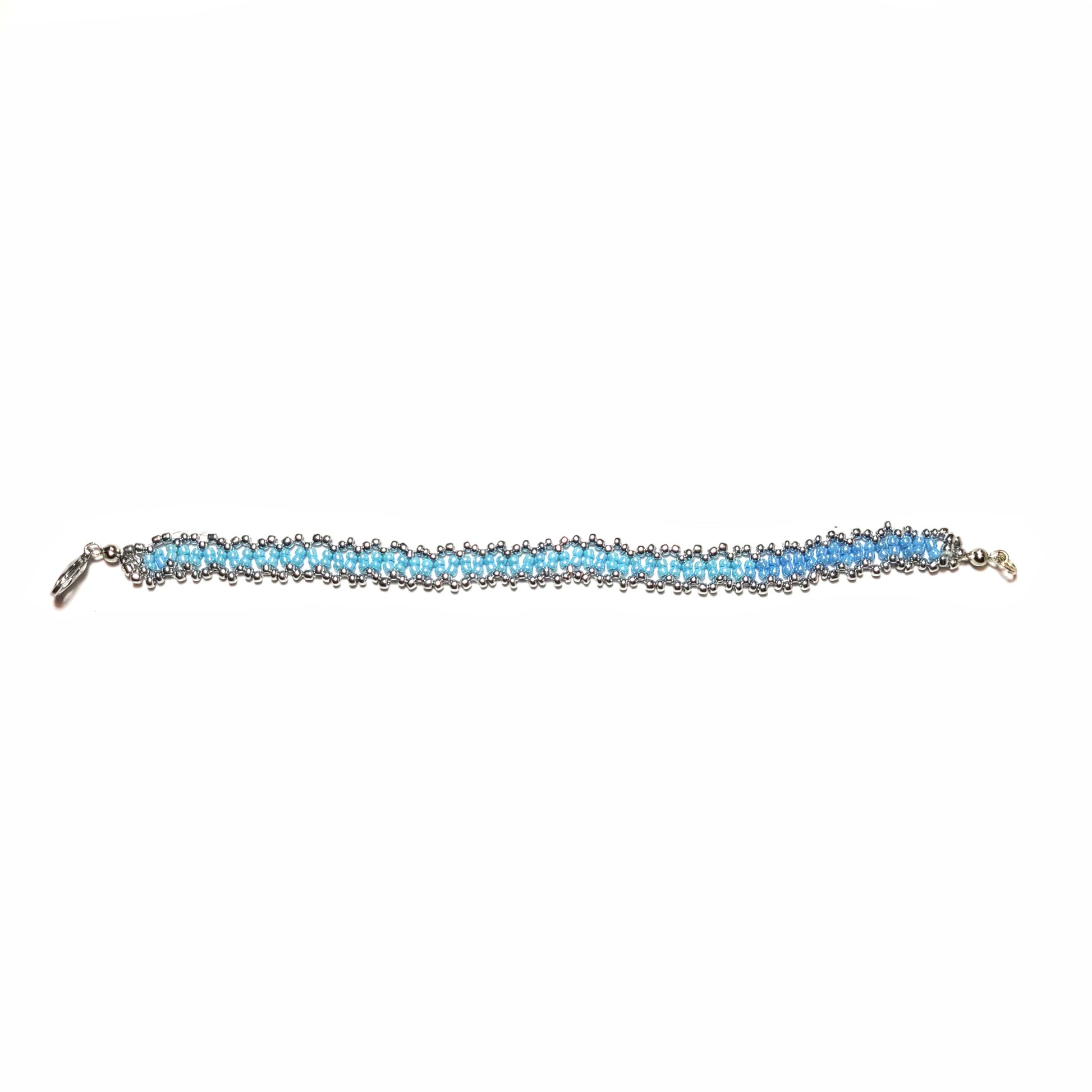 Bracelet made with powder blue and silver colored seed beads, with a silver colored lobster clasp.