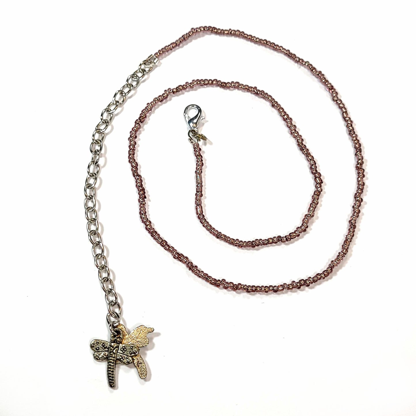 Single strand brown seed bead necklace with an extender that has 2 dragonfly charms on the end.