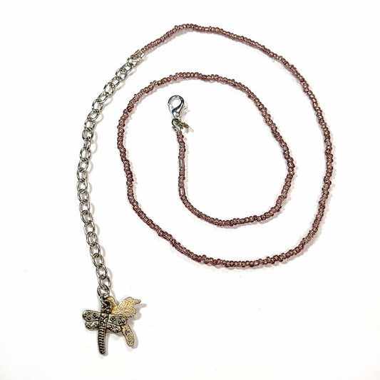 Single strand brown seed bead necklace with an extender that has 2 dragonfly charms on the end.