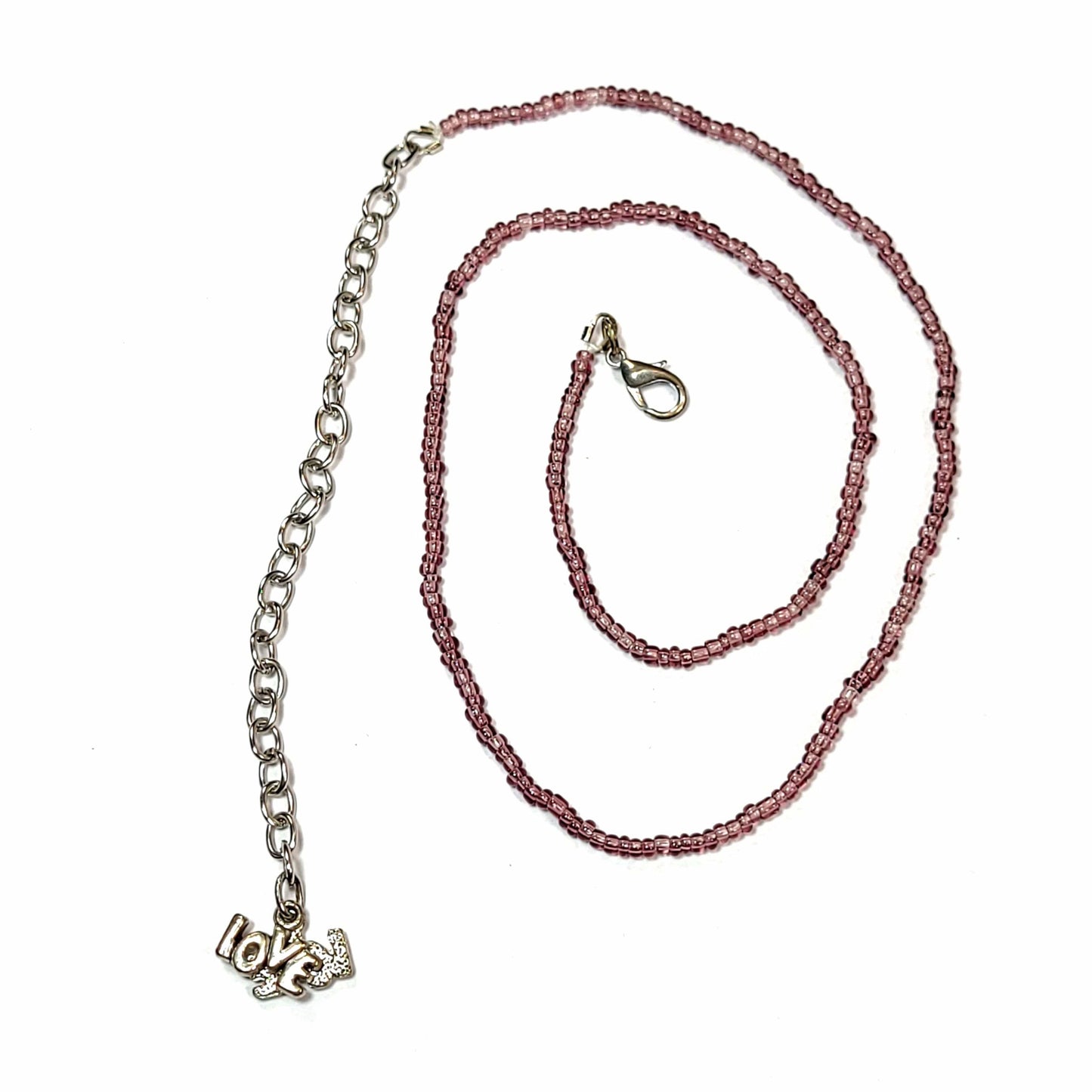 Single strand brown seed bead necklace with an extender that has 2 love charms on the end.