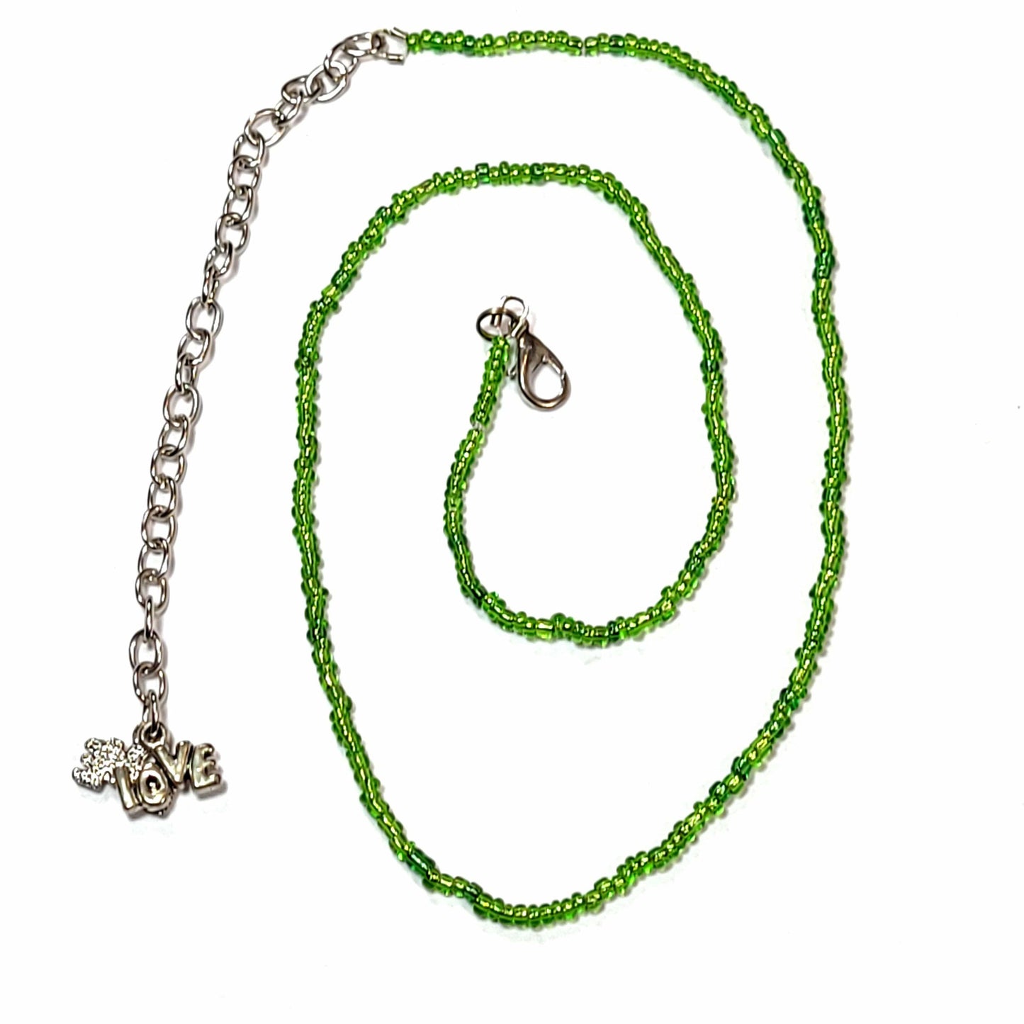 Single strand green seed bead necklace with an extender that has 2 love charms on the end.