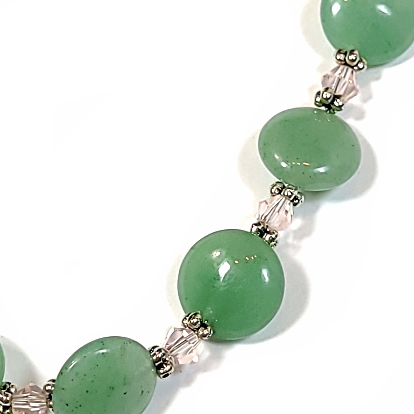 Aventurine disc beads with pale pink bicoone beads and silver tone spacers necklace. Close up view.