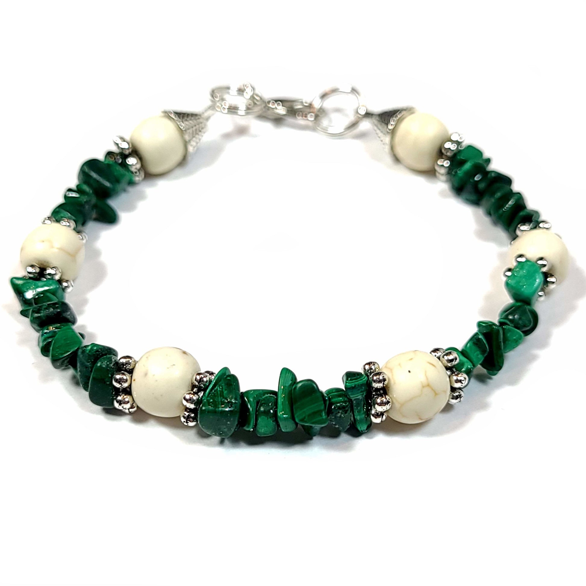 Bracelet made of malachite chips, howlite beads, silver tone spacer beads, end caps and, lobster clasp.