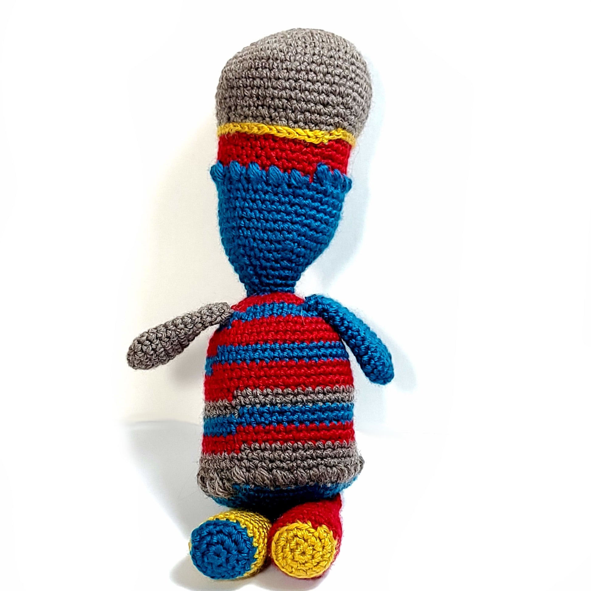 The Back of a figure, Red, Gold, Blue, and Grey unique figure hand crocheted stuffie. 
