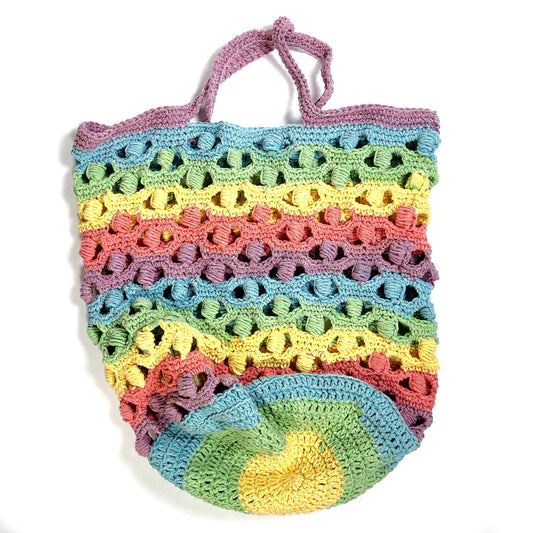 Multi-color hand crocheted tote bag. Made from Caron Cakes yarn and a pattern by Tonya from Nana's Crafty Home. The yarn colors are: lilac, yellow, light blue, peach, and light green.