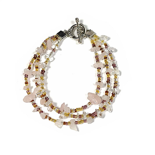 Bracelet with 3 strands of Rose Quartz chips and Multi Gold Seed beads with a toggle clasp.