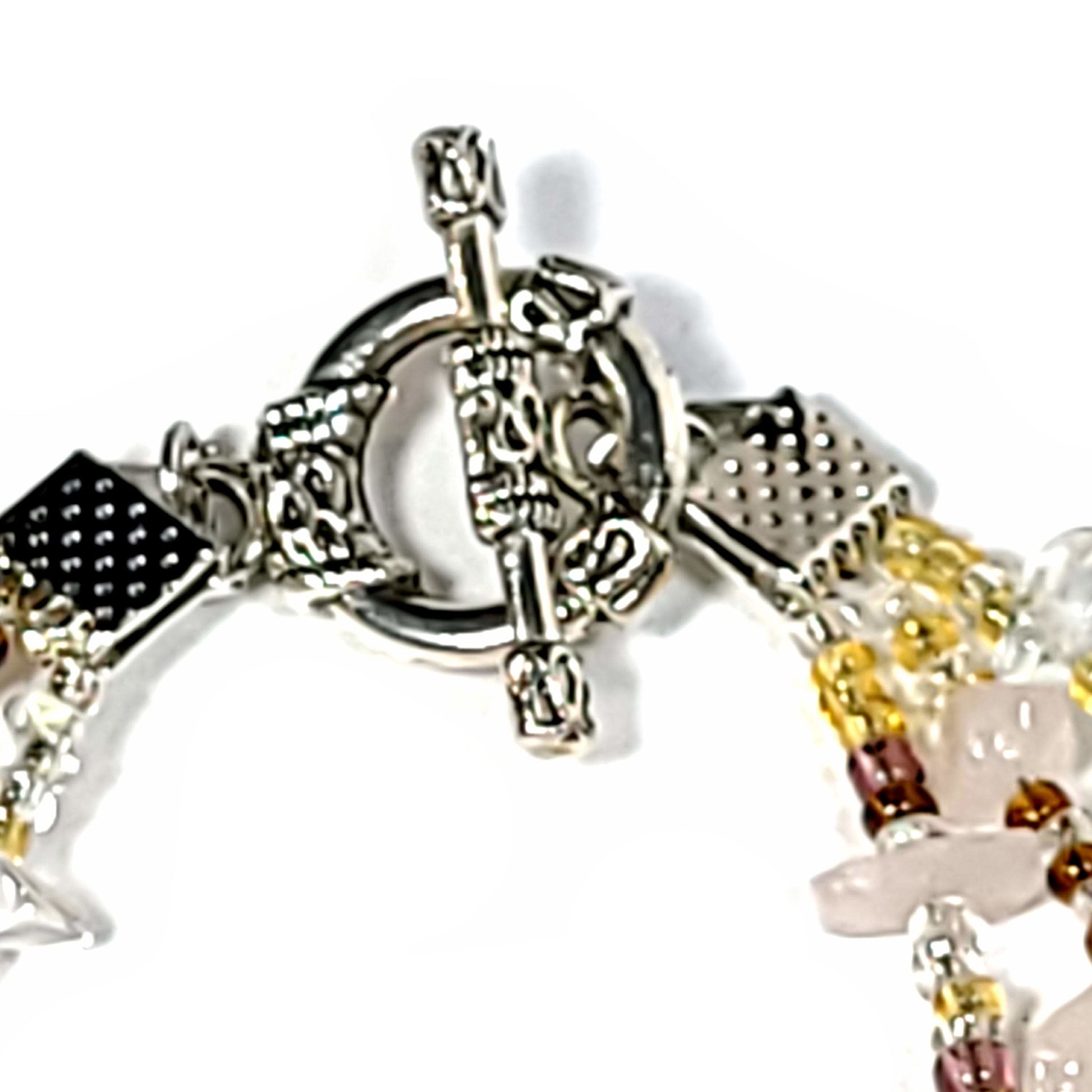 Close up of toggle clasp. Bracelet with 3 strands of Rose Quartz chips and Multi Gold Seed beads with a toggle clasp.