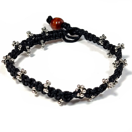 Black macrame bracelet with silver spacer beads and a wooden bead clasp.